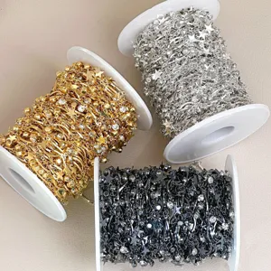 Detailed shot of DIY star rhinestone chain spools in gold, silver, and black colors.