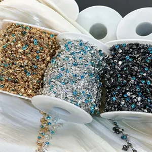 Close-up detail of DIY rhinestone heart metal chains in gold silver and black for craft jewelry.