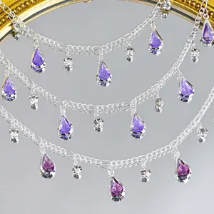 Detailed view of silver diy chain with purple teardrop crystals and small sparkling rhinestones.