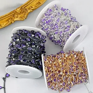Close-up detail of DIY purple rhinestone drop chains on white spools, perfect for crafting accessories.