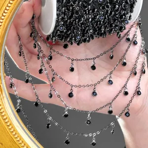 Close-up detail of black rhinestone DIY tassel chain, multi-strand dangling jewelry part.