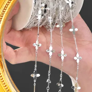 DIY silver metal chain spool featuring four-leaf clover motifs and straight bar links.