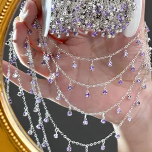 Silver rhinestone chain detail shot, featuring sparkling purple crystal pendants for DIY crafts.
