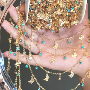 DIY gold chain with blue rhinestones and butterfly charms for jewelry making crafts.