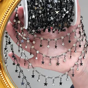 Close-up of DIY black metal rhinestone star chain, exquisite Lolita craft trim detail.