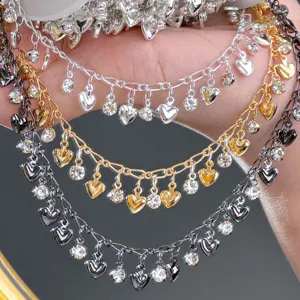 DIY metal chain detail showing multi-color rhinestone and heart charms for craft decoration.