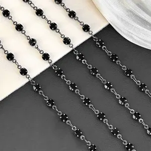 Detail view of black rhinestone chain DIY craft material, sparkling crystal trim for bags.