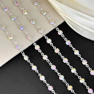 Close-up detail of sparkling AB crystal rhinestone cup chains, showing colorful multi-faceted stones.