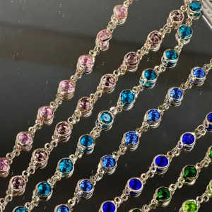 Close-up detail of colorful glass crystal rhinestone chain for DIY crafts and Hanfu hair accessories.