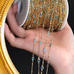DIY gold tone chain with blue bezel set stones detail shot for handmade jewelry making.