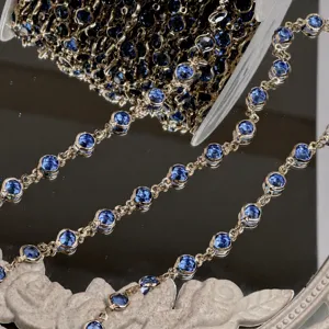 Detail view of DIY blue crystal rhinestone chain with gold base for jewelry making.