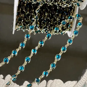 Close-up detail of blue crystal chain with gold-colored settings for DIY crafts and hair accessories.