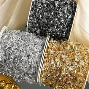 Close-up view of multi-color heart rhinestone DIY chains, showing gold, silver, and black rolls.