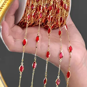 Close-up detail of gold-plated navette red stone DIY chain material for decorative crafts.