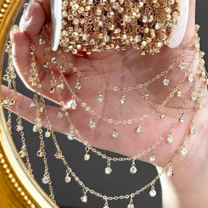 Close-up of gold DIY rhinestone chain, sparkling crystal beaded trim for handmade jewelry.