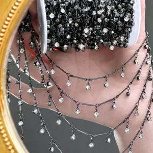 Detail view of DIY black gunmetal rhinestone fringe chain for hair and costume decoration.