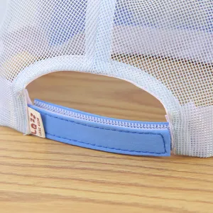 Close-up detail of the breathable mesh back strap and label on the kids baseball cap.