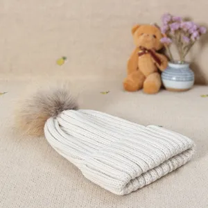 White knitted beanie winter hat with fluffy fur pom pom cozy warm casual style for women