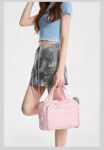 Stylish pink puffer handbag, lightweight waterproof cosmetic and travel storage bag for daily use.