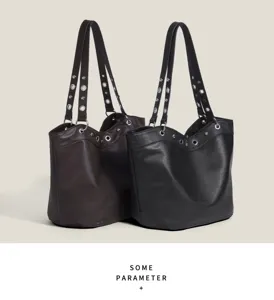 Close-up of litchi pattern leather tote bag showing metal rivets and double straps.