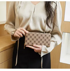 Detailed view of women's brown printed zipper clutch wallet, chic daily accessory.