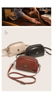 Detail shot of vintage oil wax leather shoulder bag, multi-compartment design, elegant style.