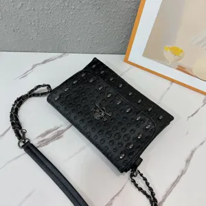 Punk style women black envelope bag with metal chain strap, skull studs and cool design details.