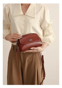 Detail of retro oil-wax leather shoulder crossbody bag for women, elegant shell bag design.