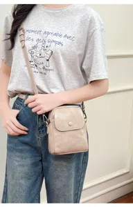Detailed view of casual beige PU leather small square crossbody bag with flap and button.