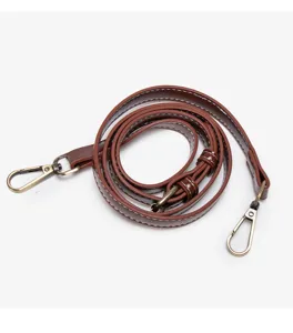 Brown leather replacement shoulder strap detail, adjustable metal buckle hooks.