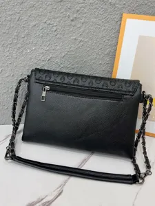 Punk style black leather skull embossed chain shoulder envelope bag for women daily fashion.