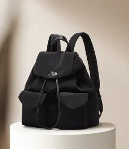 Black nylon backpack with front pockets, metal lock clasp, and casual Korean style.