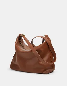 Detailed view of the stylish brown slouchy shoulder bag with large capacity and zipper.