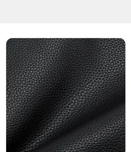 Black leather texture detail close-up showing fine pebble grain pattern and soft touch.