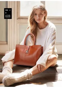 Brown leather tote bag detail, large capacity vintage handbag for women daily commuting style.