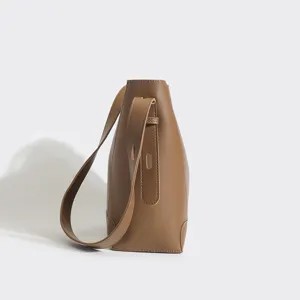 Minimalist brown leather bucket bag for women, large capacity stylish shoulder and crossbody bag.