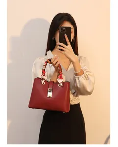 Stylish red leather handbag with scarf handle, elegant tote bag for women daily commute.