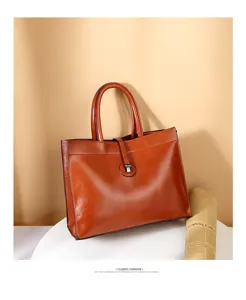 Detailed view of brown leather commuter handbag, large capacity tote bag for daily fashion.