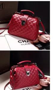 Red quilted Boston doctor bag with metal clasp, top handle and adjustable shoulder strap.