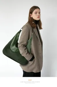Detailed view of women's retro large capacity leather shoulder underarm hobo bag on model.
