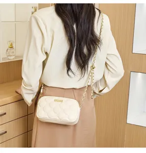 Detailed shot of the chic quilted shoulder bag with gold chain strap, ideal for daily wear.