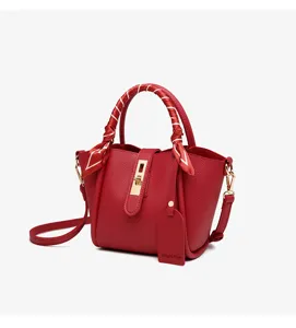 Red leather bucket bag with scarf handle and metal clasp for women stylish commute