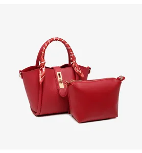 Red bucket tote bag with matching pouch and stylish scarf handle, chic commuter handbag.