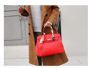 Red leather handbag with metal lock and twilly scarf, stylish shoulder bag for women.