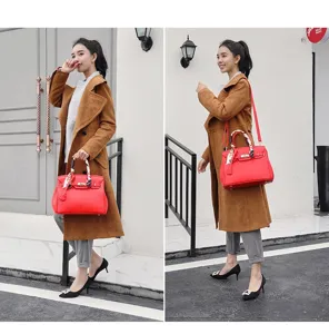 Red litchi pattern leather handbag with lock clasp, styled as a chic shoulder crossbody bag.