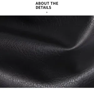 Close-up detail shot of premium black litchi grain faux leather texture surface handbag.