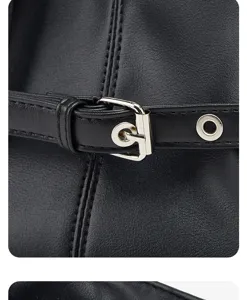 Close-up of black leather bag strap with metallic buckle and eyelet detail, premium texture.