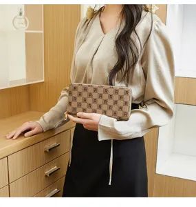 Brown monogram clutch wallet for women, stylish vintage wristlet purse with zipper closure.