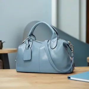 Blue boston handbag for women, stylish minimalist crossbody shoulder bag with top handle.