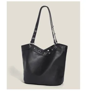 Black leather tote shoulder bag featuring metallic grommets and rivets for chic look.